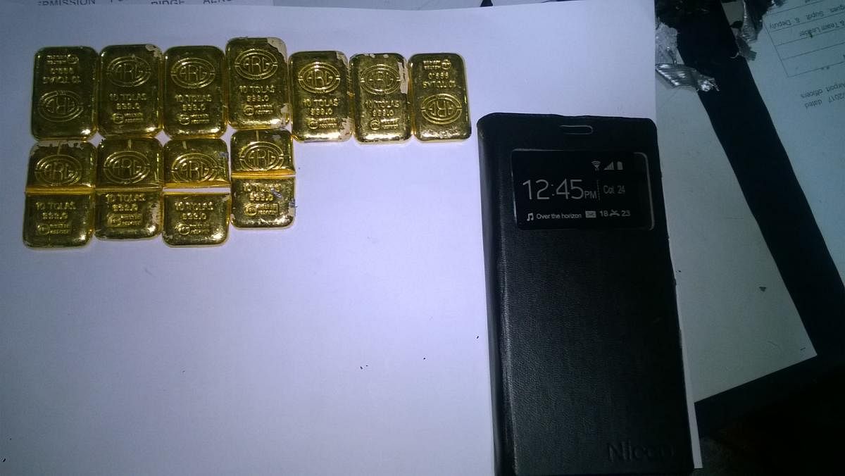 Gold bars, concealed inside a mobile phone-like object, seized at the Mangalore International Airport on Wednesday. dh photo