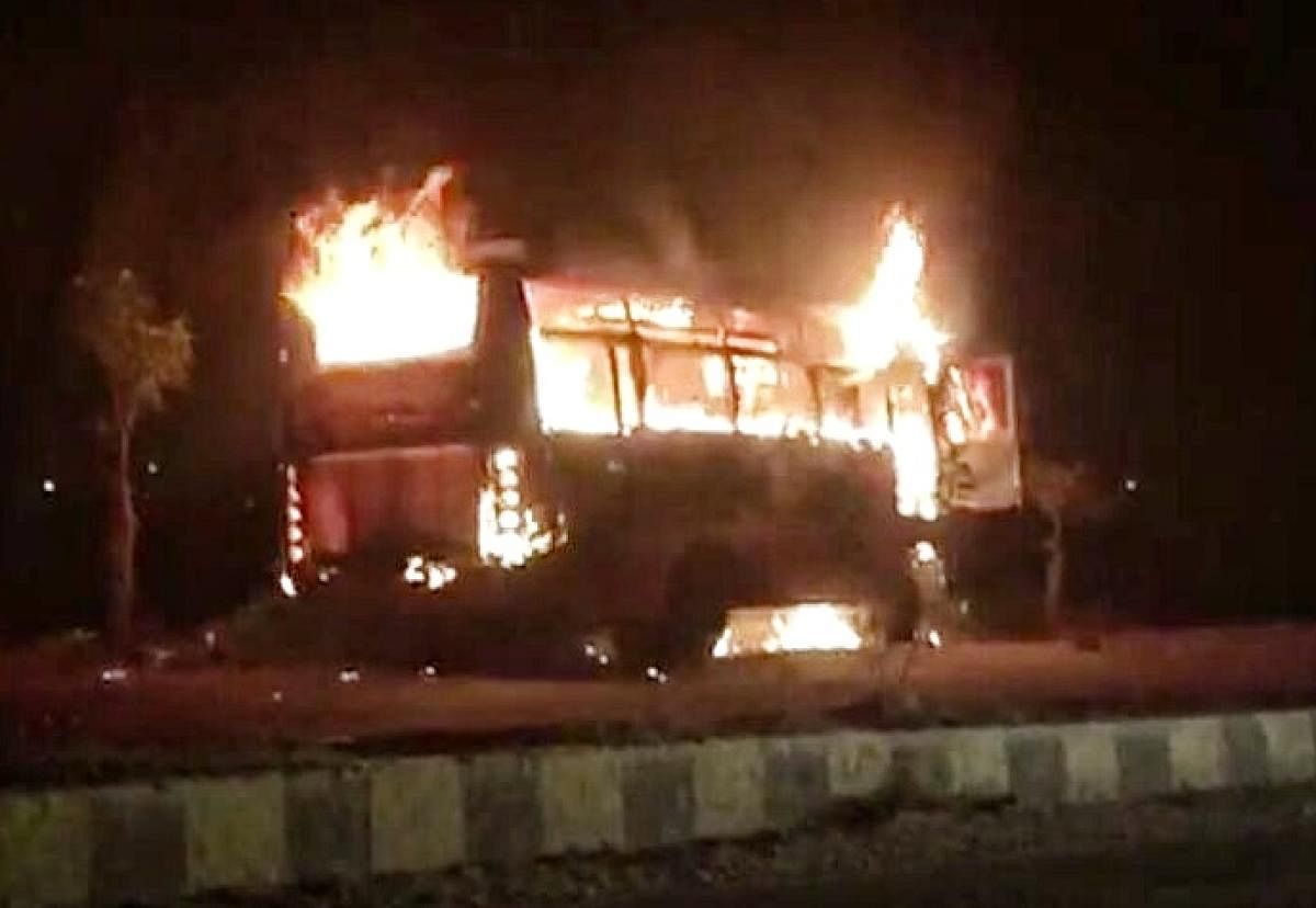 The minibus which caught fire on the outer ring road near Hosapete on Friday.