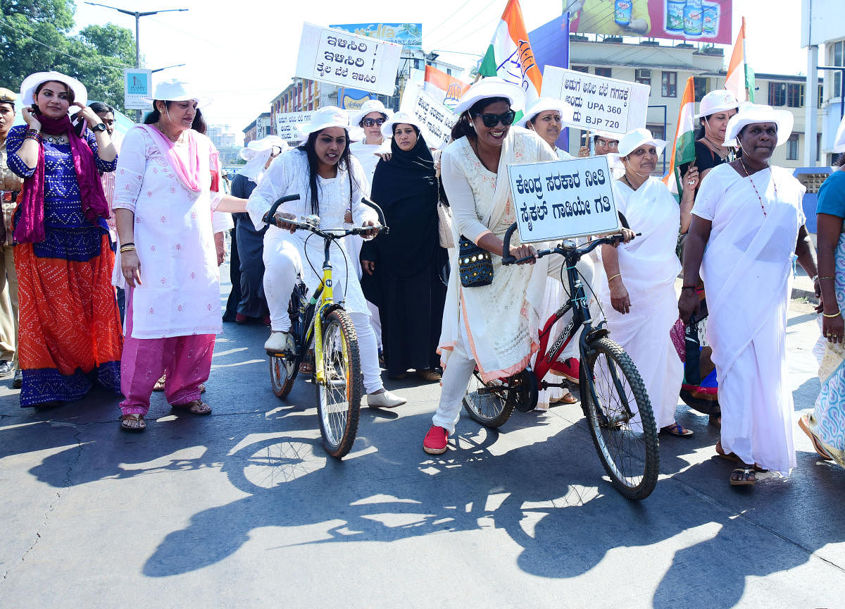 Mayor Kavitha Sanil and other Women Congress members ride bicycles in Mangaluru on Saturday protesting against rise in price of fuel.