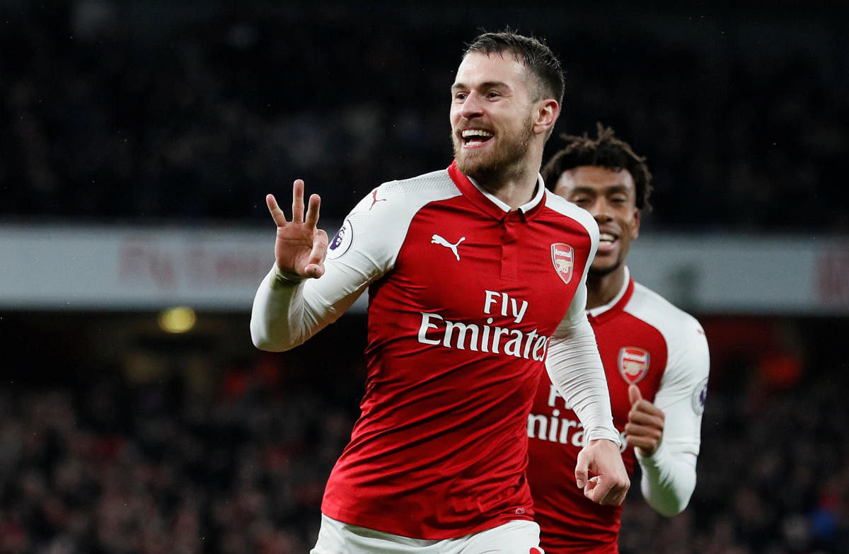 Arsenal's Aaron Ramsey celebrates after completing his hat-trick against Everton during their EPL game on Sunday. Reuters.