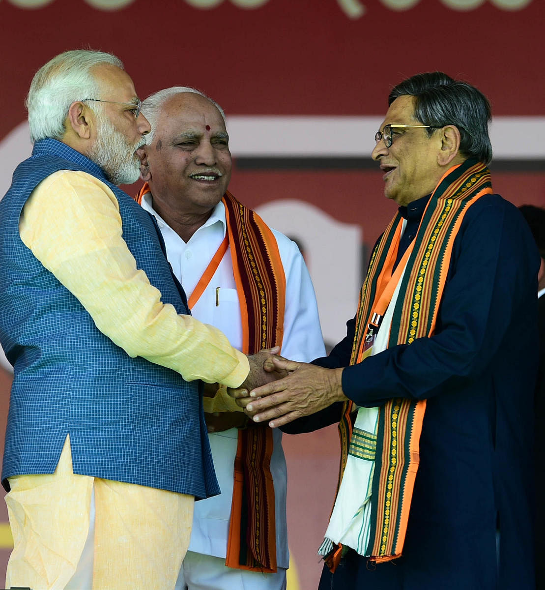 Narendra Modi greets S M Krishna at the rally.