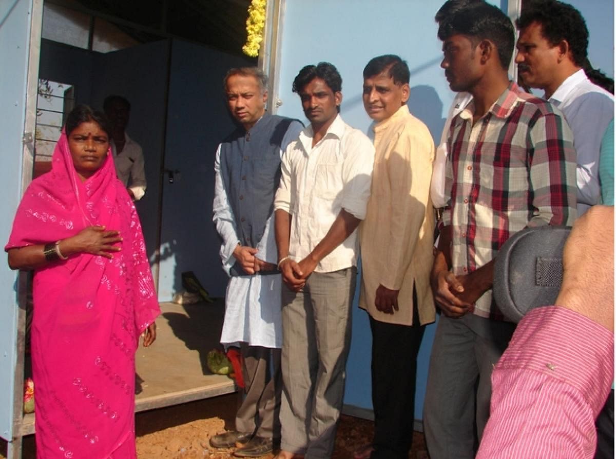 Selco Foundation chairman Dr Harish Hande inaugurates houses for urban migrants, at Mullikatte in Baindur on Sunday.