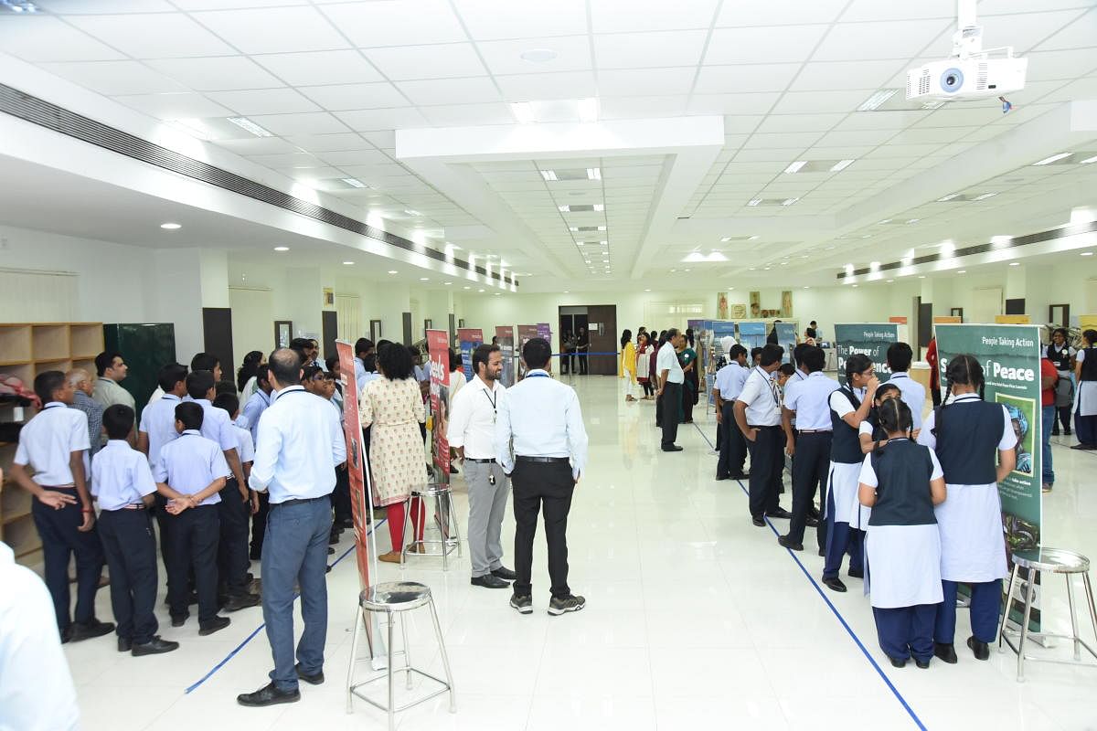 Students view the exhibits at the 'Seeds of Hope' expo in Manipal.