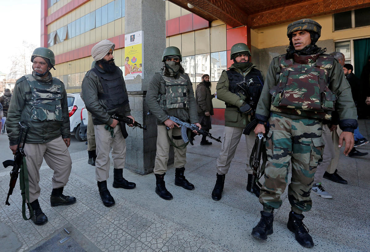 Policemen stand guard after militants opened fire at a police party inside a hospital in Srinagar on Tuesday. REUTERS