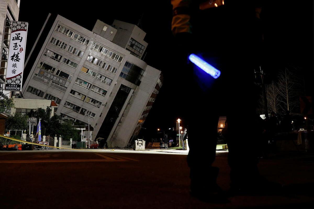 A police officer stands guard outside a damaged building after an earthquake hit Hualien. Reuters Photo