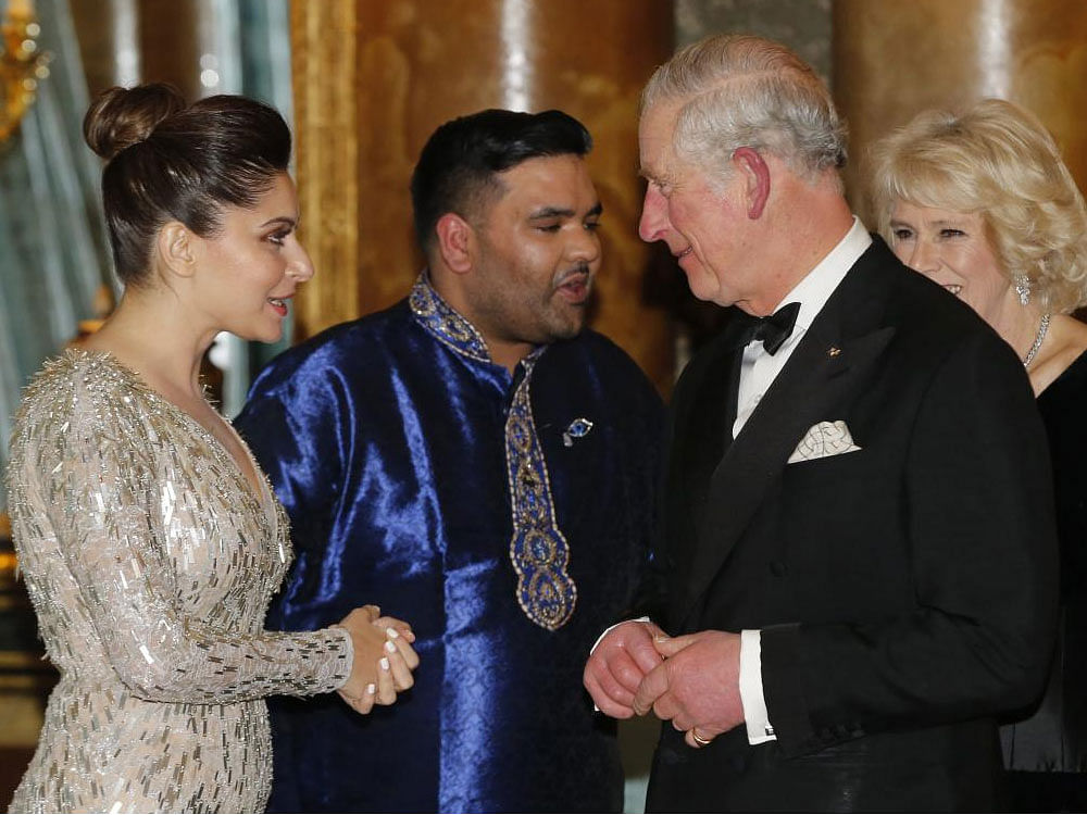 Prince Charles greets singer Kanika Kapoor during a reception for the Britain Asian Trust at Buckingham Palace in London. AP,PTI Photo