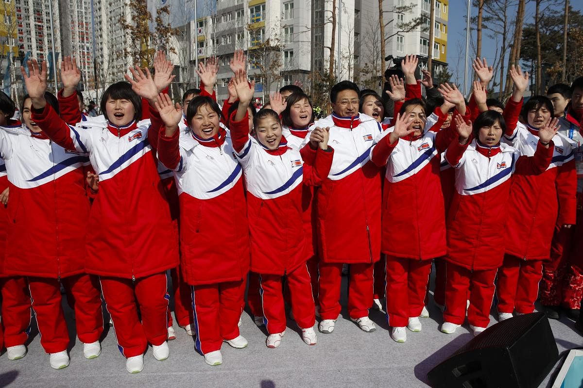 North Korean athletes, led by Won Gil-woo, fourth from right, wave as they pause for photos during a welcome ceremony at the Olympic Village ahead of the 2018 Winter Olympics in Gangneung, South Korea. AP/PTI Photo