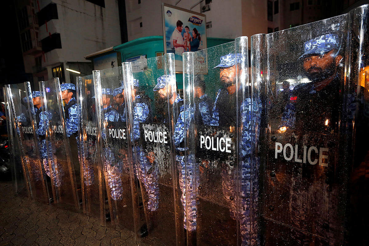 Maldivian police stand guard on a main street during a protest by opposition supporters against the government's delay in releasing their jailed leaders, including former president Mohamed Nasheed, despite a Supreme Court order, in Male. Reuters file photo