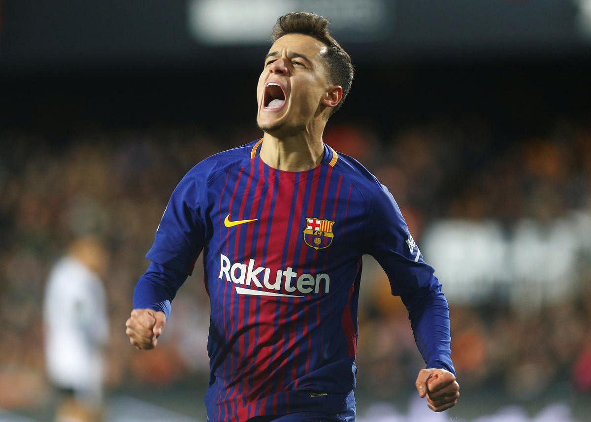 Jubilant: Barcelona's Philippe Coutinho celebrates after scoring against Valencia on Thursday. REUTERS