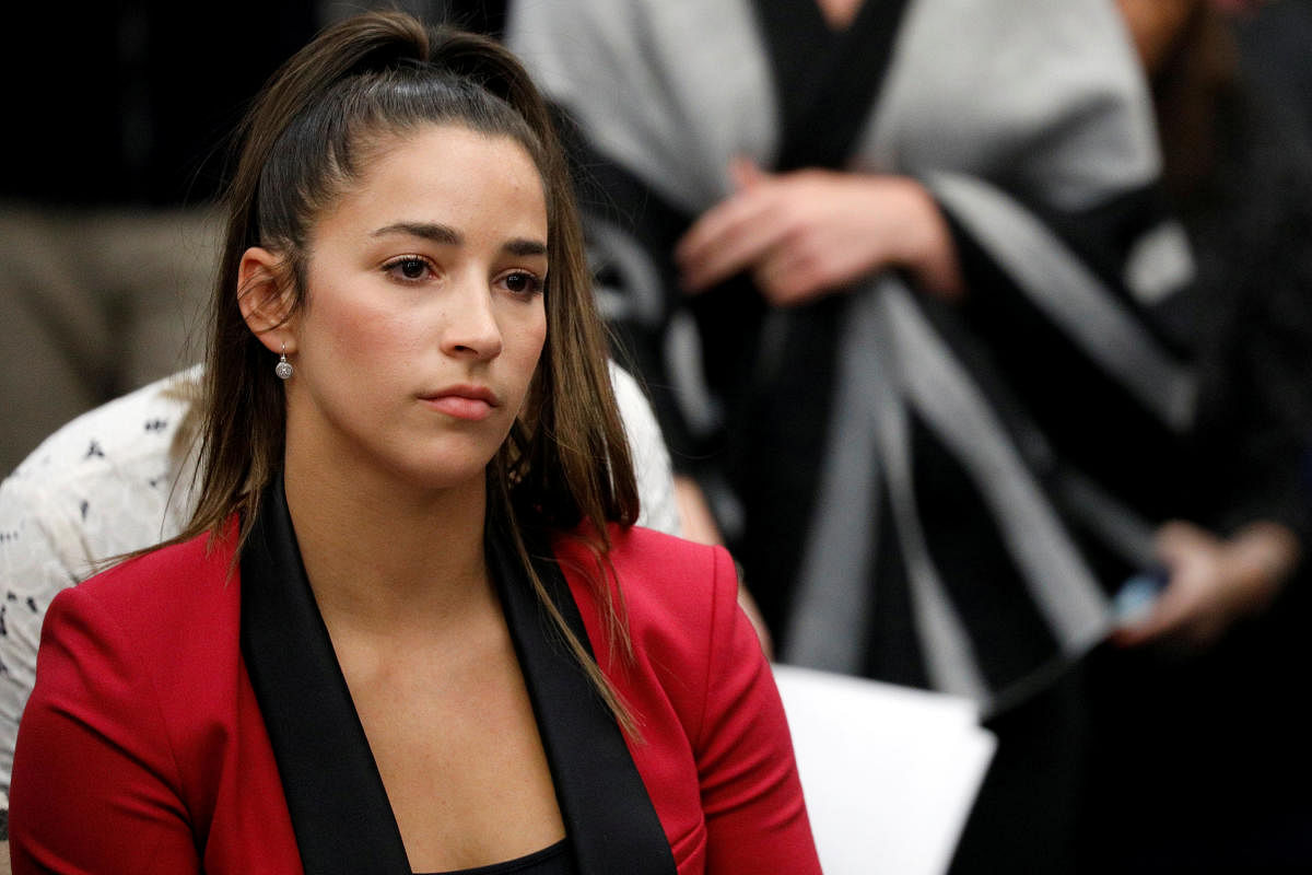 REFILE - CORRECTING IDENTITY OF ALY RAISMAN Victim and Olympic gold medalist Aly Raisman appears before speaking at the sentencing hearing for Larry Nassar, a former team USA Gymnastics doctor who pleaded guilty in November 2017 to sexual assault charges, in Lansing, Michigan, U.S., January 19, 2018. REUTERS/Brendan McDermid