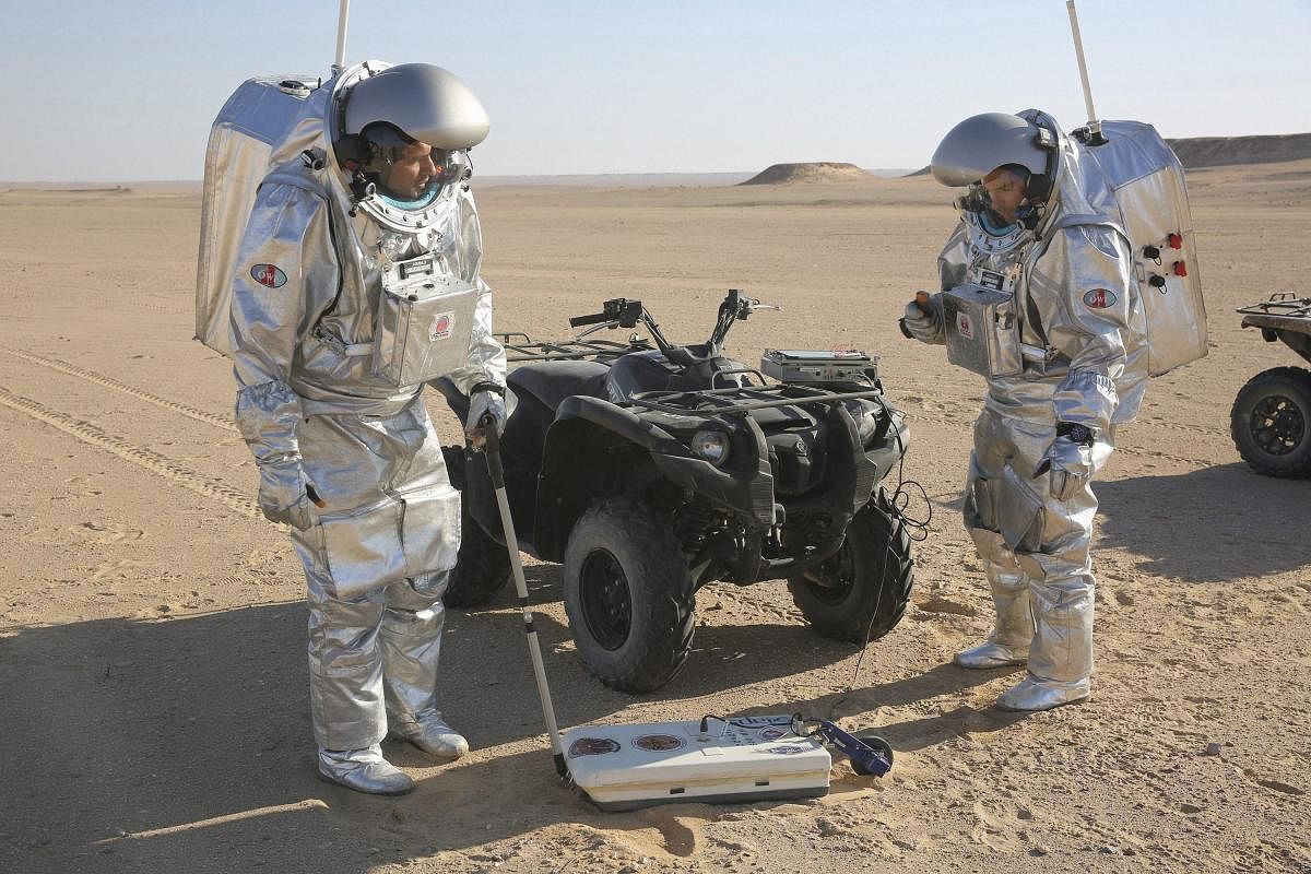 Two scientists test space suits and a geo-radar for use in a future Mars mission in the Dhofar desert of southern Oman. The desolate desert in southern Oman resembles Mars so much that more than 200 scientists from 25 nations organized by the Austrian Space Forum are using it for the next four weeks to field-test technology for a manned mission to Mars. AP/PTI