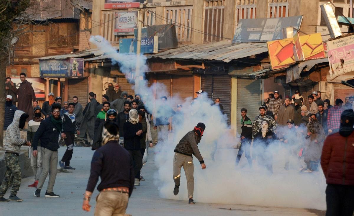 A protestor throws teargas shell at police during a clash in Srinagar. The unrest was caused over the killing of five civilians in an army firing in Shopian district. PTI