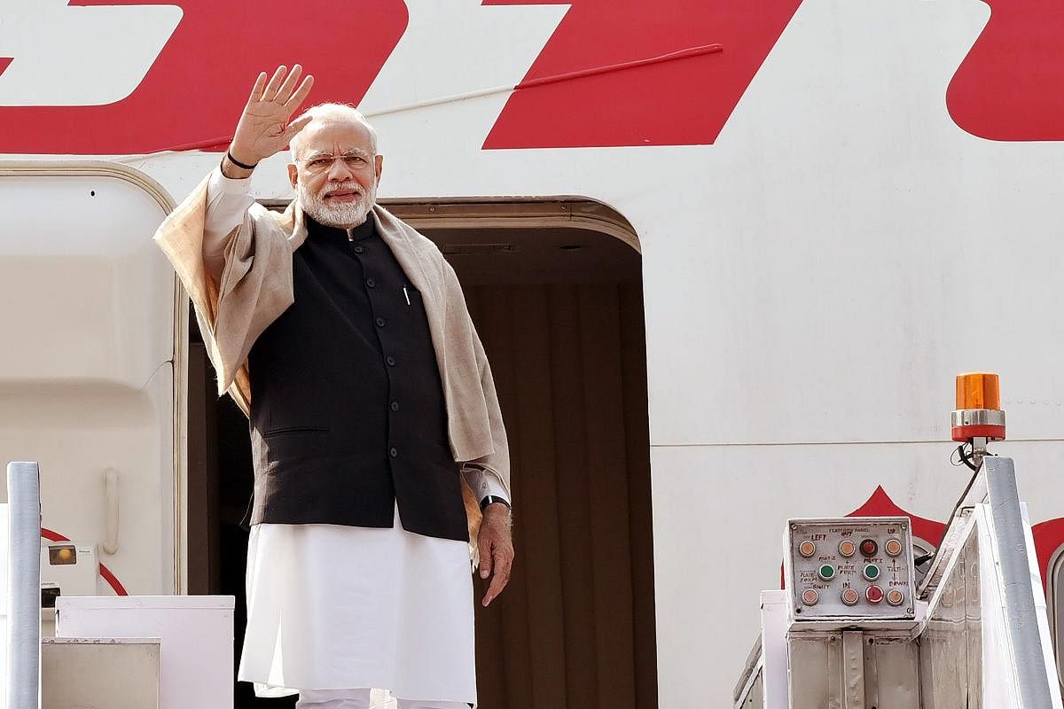 Prime Minister Narendra Modi waves as he embarks on a 4-day visit to Jordan, Palestine, UAE and Oman from New Delhi on Friday. PTI