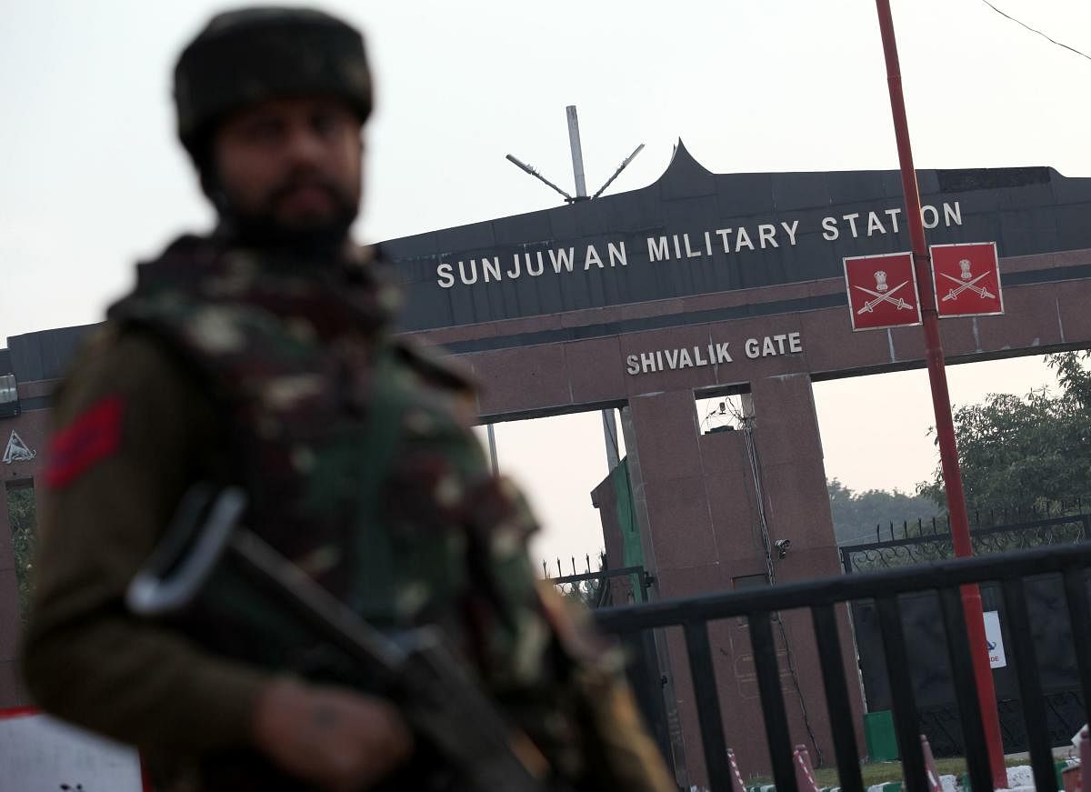 An Indian soldier stands guard at the entrance of the Sunjuwan Military Station in Jammu