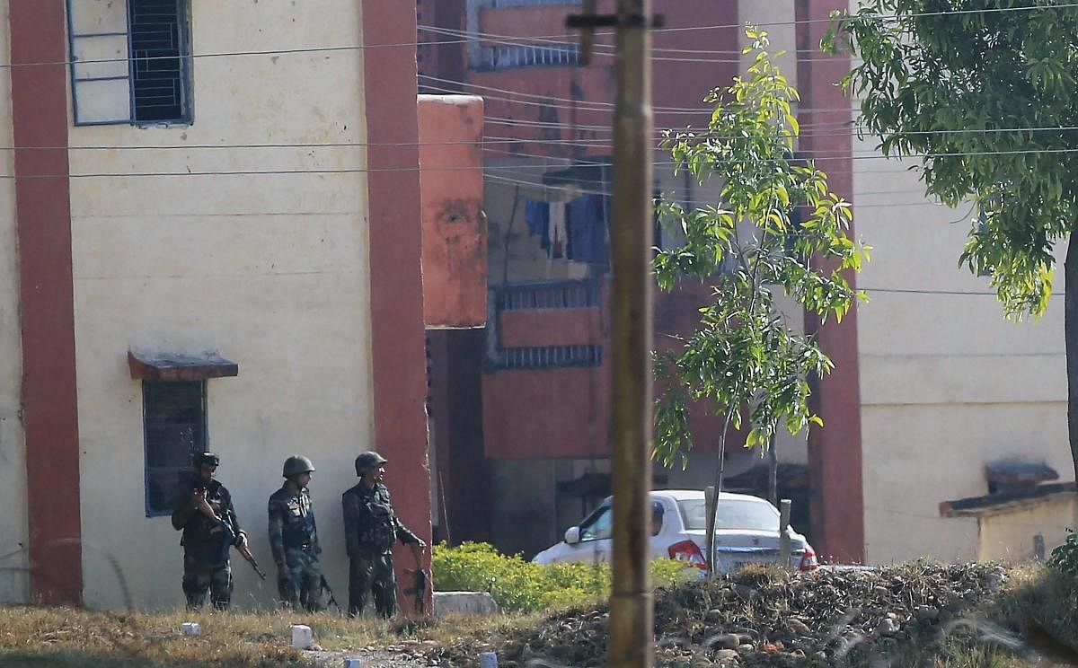 Security personnel take position around the family quarters of 36 Brigade army camp in Sunjuwan area after the terrorist attack, in Jammu on Saturday morning. PTI Photo