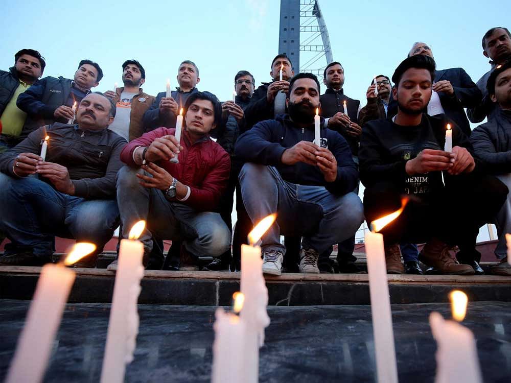 People light candles during a vigil held for the army officers who were killed in an attack earlier this morning at an army camp, in Jammu. Reuters Photo