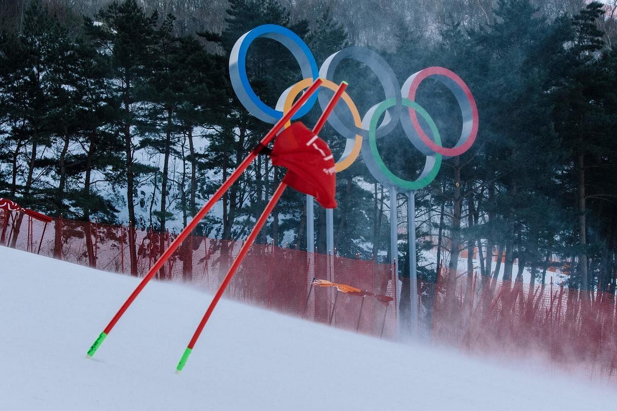 VOLATILE CONDITIONS A gate flag flutters in the wind after the women's giant slalom was postponed due to high winds. AFP
