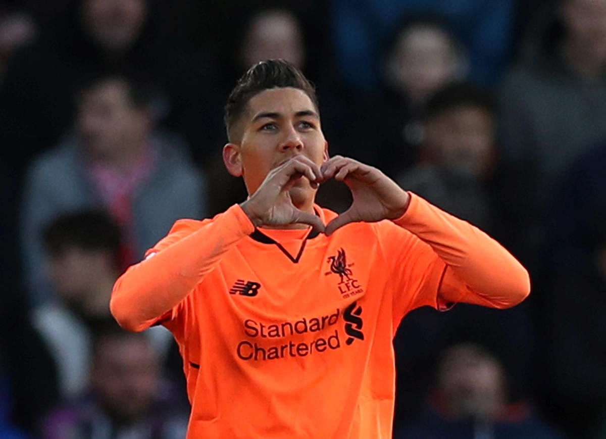 ON TARGET Liverpool's Roberto Firmino celebrates scoring their first goal against Southampton on Sunday. Reuters