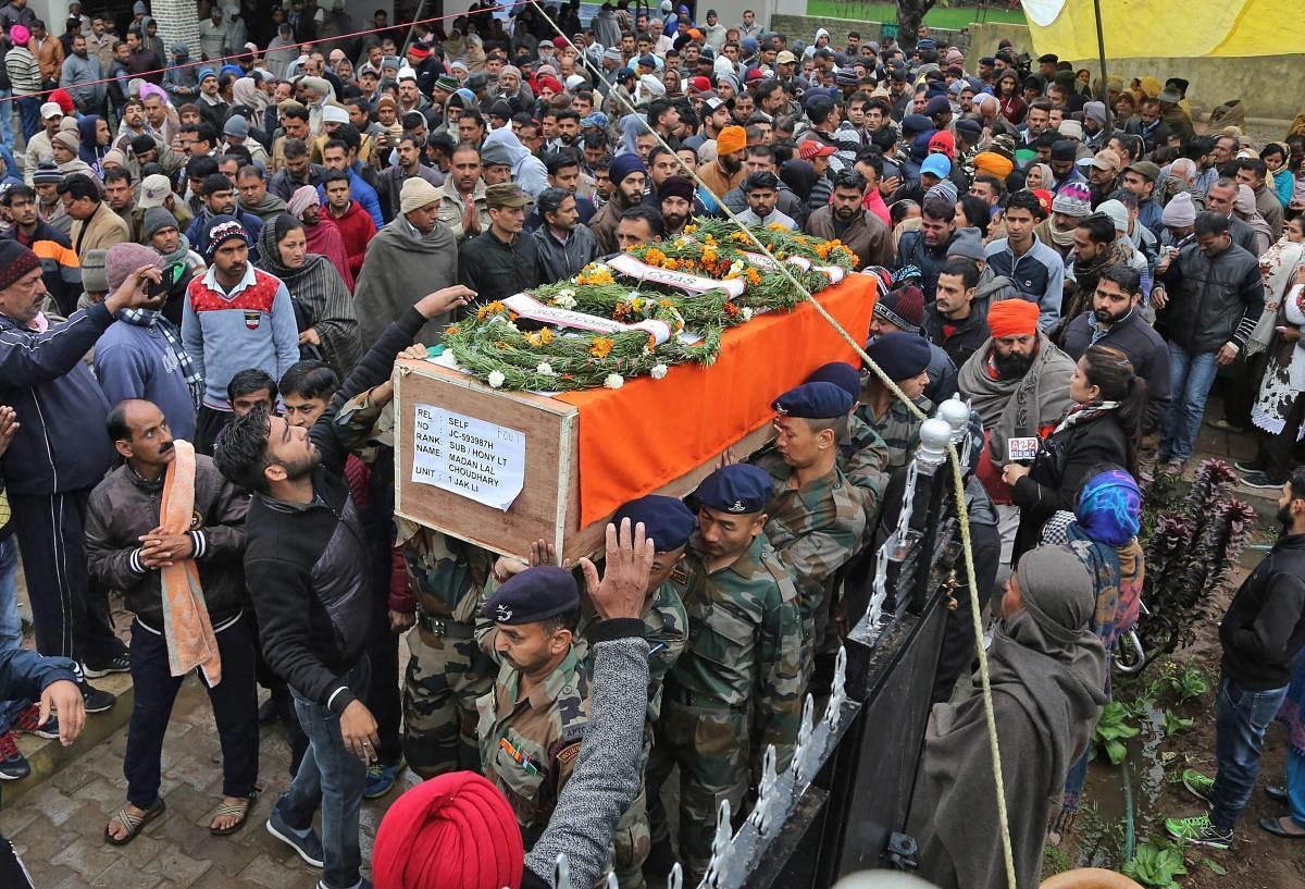 Army officer and jawans carry the body of Indian Army JCO Madan Lal Choudhary, who was killed in a terrorist attack at Sunjuwan Army camp, for his final rites in Hiranagar near Jammu on Monday. PTI