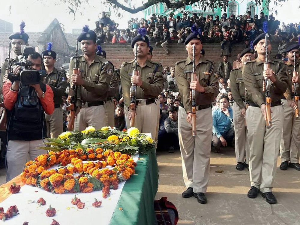 CRPF personnel pay gun salute to Constable Mujahid Khan, who was killed in the terrorist attack at Jammu's Sunjuwan Army Camp, at Piro in Bhojpur district of Bihar on Wednesday. PTI Photo