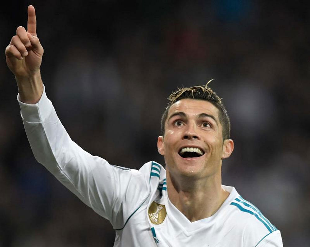 MILESTONE MAN Real Madrid's Cristiano Ronaldo celebrates after scoring his second goal against Paris St Germain during their Champions League clash on Wednesday. REUTERS