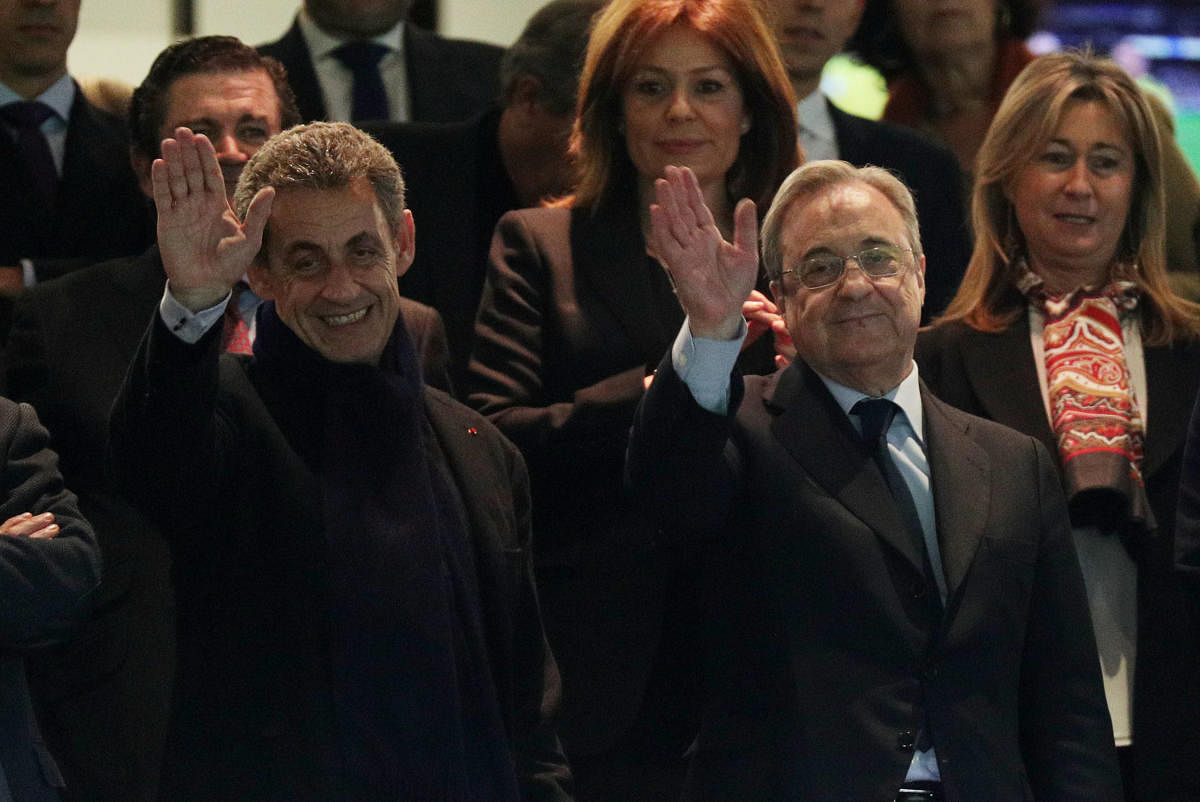 THE KINGPIN: Real Madrid president Florentino Perez (right) waves to the crowd along with former French president Nicolas Sarkozy. Such high profile personalities are regular guests of Perez during match days at Santiago Bernabeu. REUTERS