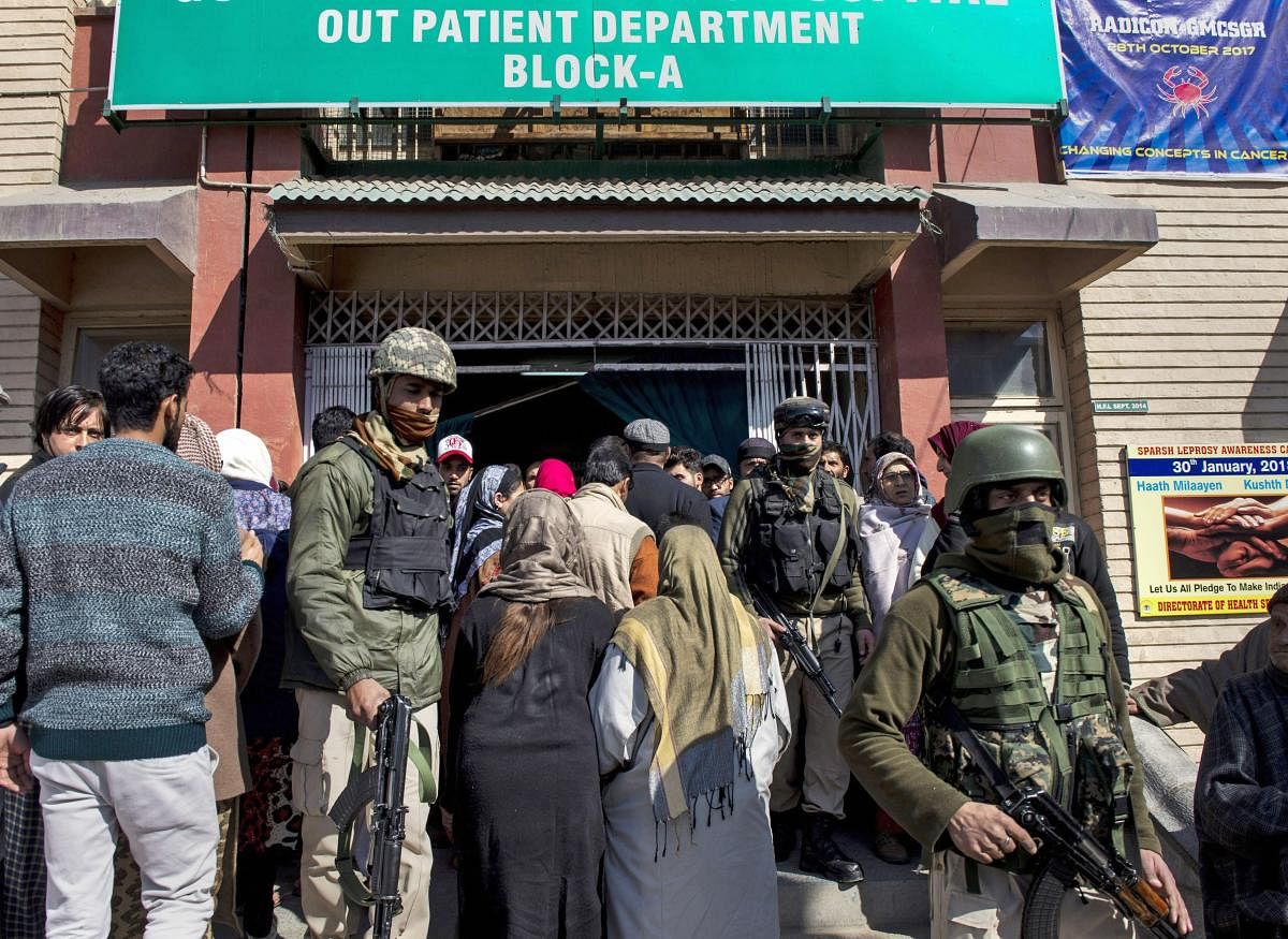 Security personnel stand guard during a search operation after an LeT militant escaped from the police custody with the assailants after Lashkar-e-Toiba ultras attacked SMHS hospital, in Srinagar. PTI