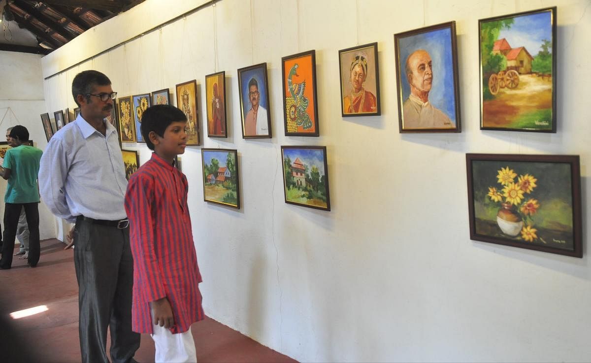 Visitors viewing the art works exhibited at Vibhoothi Art Gallery in Udupi on Monday.