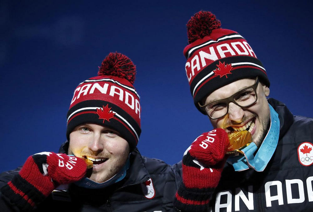 Canadian Gold medalists Alexander Kopacz and Justin Kripps of Canada on the podium. Reuters photo.