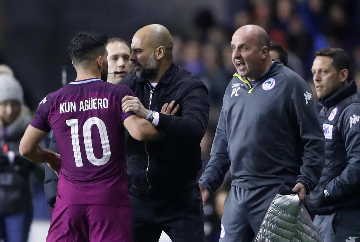 TEMPERS RUNNING HIGH: Manchester City's Sergio Aguero (left) got into a tussle with fans after his side's loss to Wigan Athletic on Monday. Reuters