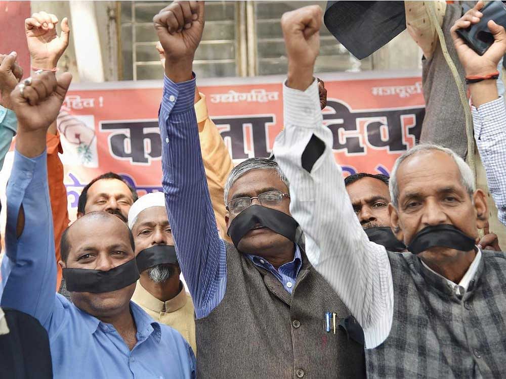 Members of Bharatiya Mazdoor Sangh raise slogans during a protest against the Union budget in Patna. PTI Photo