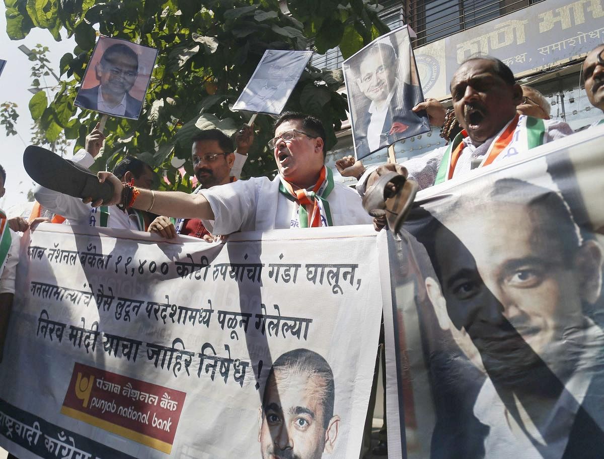 NCP activists raise slogans during a protest against Nirav Modi in the Punjab National Bank fraud case in Thane, Mumbai on Saturday. PTI Photo