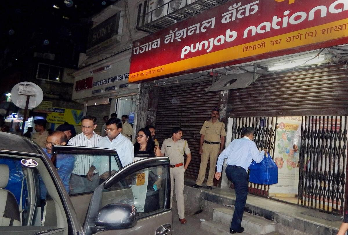 Enforcement Directorate (ED) officials outside PNB branch in Thane after they seized cash, jewellery and bonds worth several crores during a raid in relation to Nirav Modi-PNB scam in Thane on late Monday. PTI photo