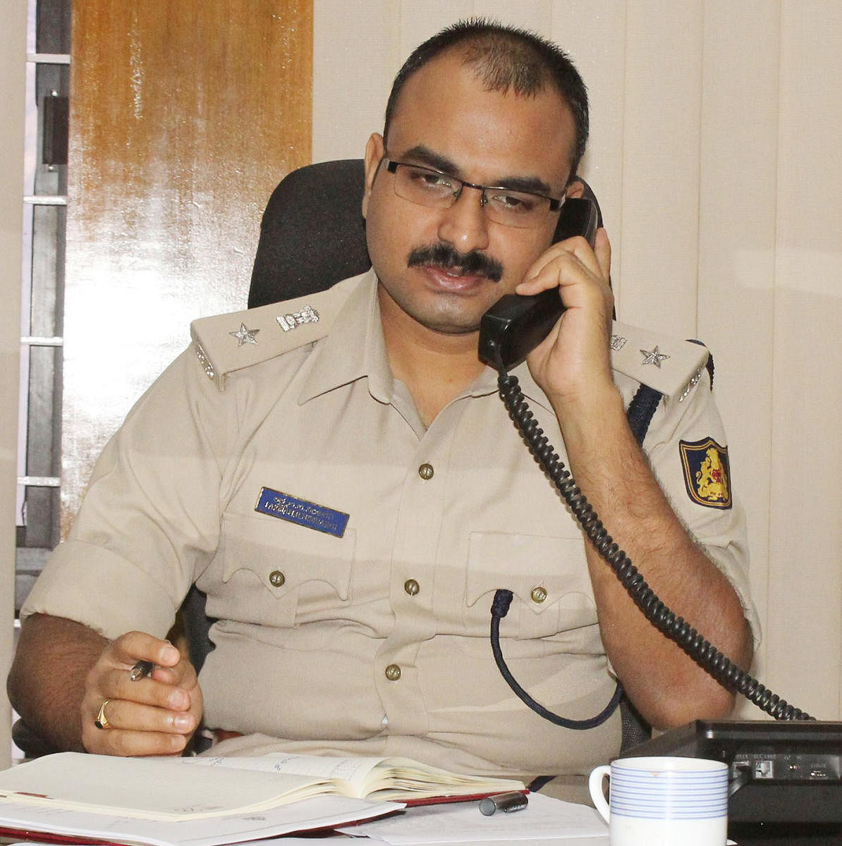 SP Lakshman Nimbargi responds to a call during a phone-in programme in Udupi on Friday.