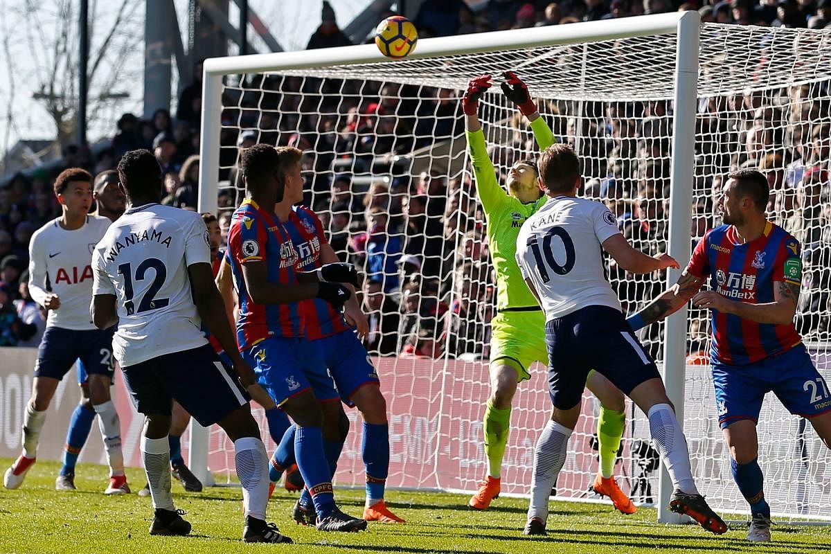 MAN WITH MAGIC TOUCH Tottenham Hotspur's Harry Kane (second from right) heads home the winner past Crystal Palace's goalkeeper Wayne Hennessey on Sunday. AFP