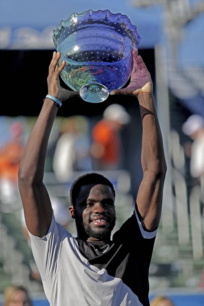 BIG MOMENT Frances Tiafoe hoists the Delray Beach open trophy after beating Peter Gojowczyk in the final on Sunday. AP-PTI