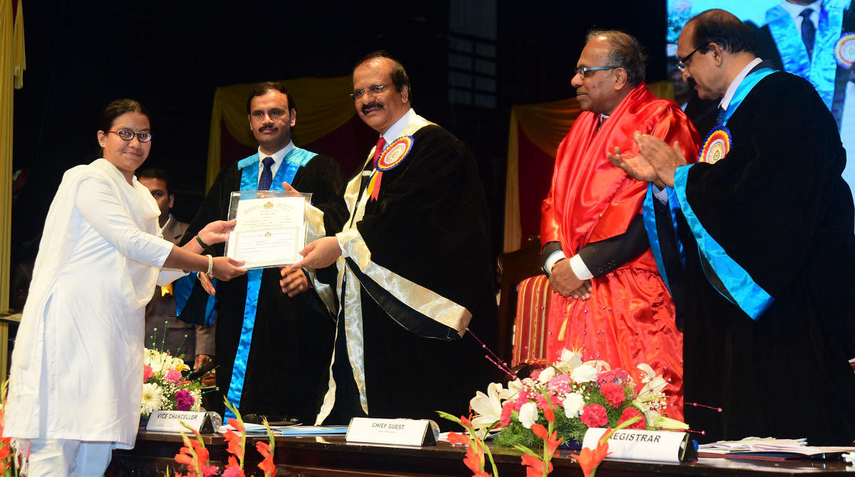 Chandanaa K S receives a gold medal and cash prize at the 36th convocation of Mangalore University on Monday.