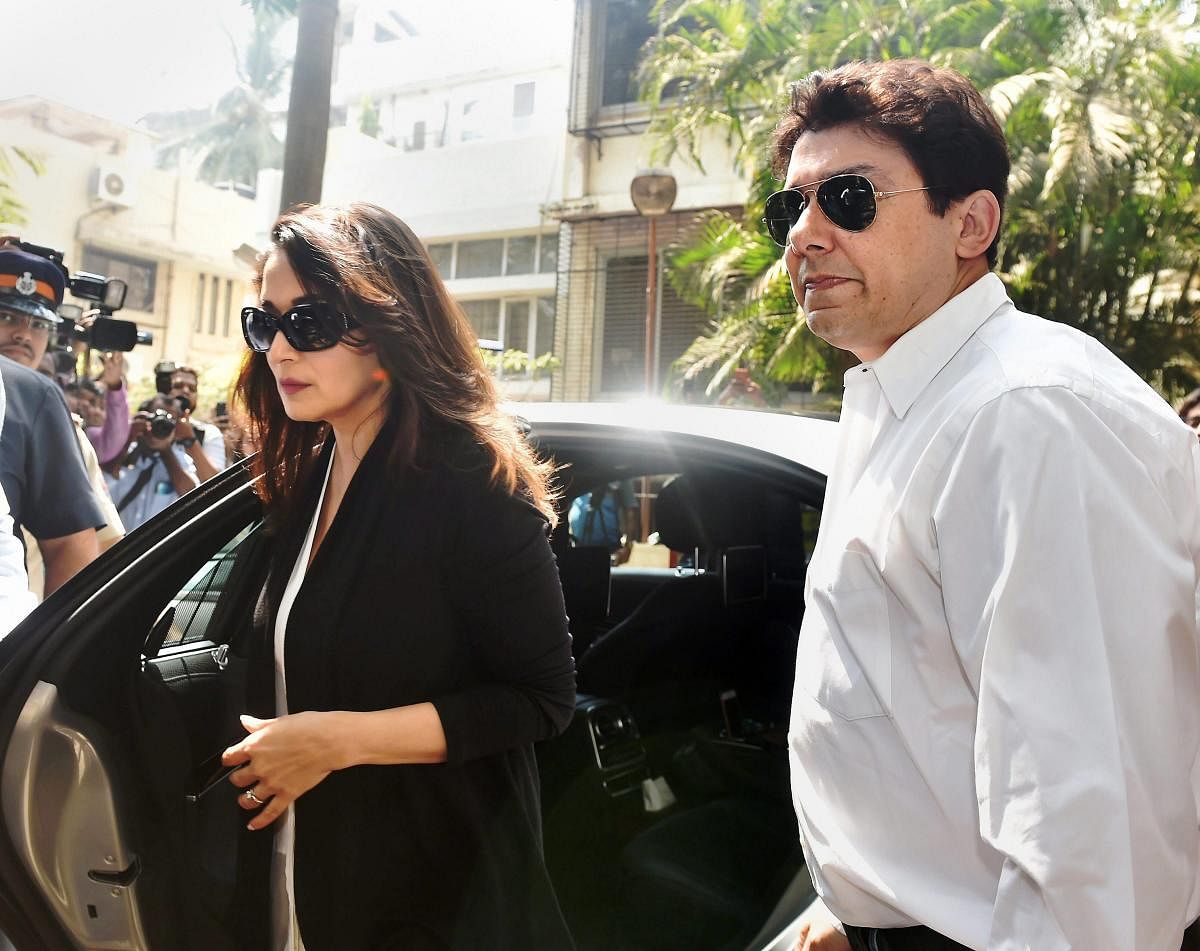 Actor Madhuri Dixit with her husband Sriram Nene arrive at the residence of actor Anil Kapoor following the demise of actor Sridevi in Mumbai on Monday. PTI