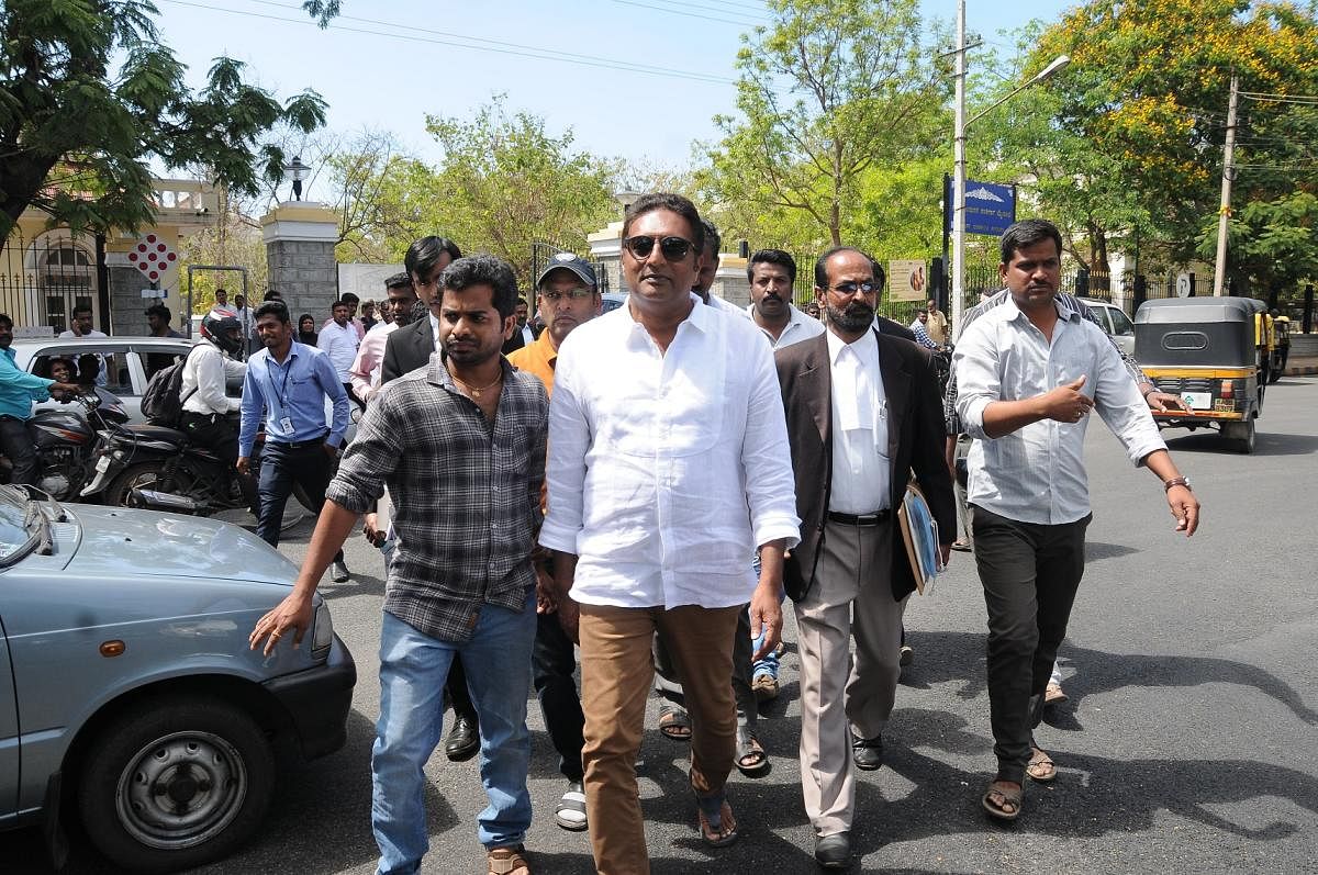 Praksah Rai comes out of the court complex, along with his supporters and lawyer, in Mysuru on Tuesday. dh photo
