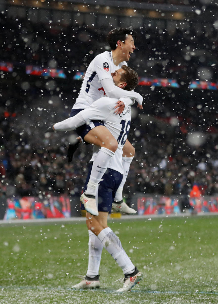 Jubilant: Tottenham Hotspurs' Fernando Llorente celebrates with team-mate Son Heung-min after completing his hat-trick against Rochdale on Wednesday. Reuters