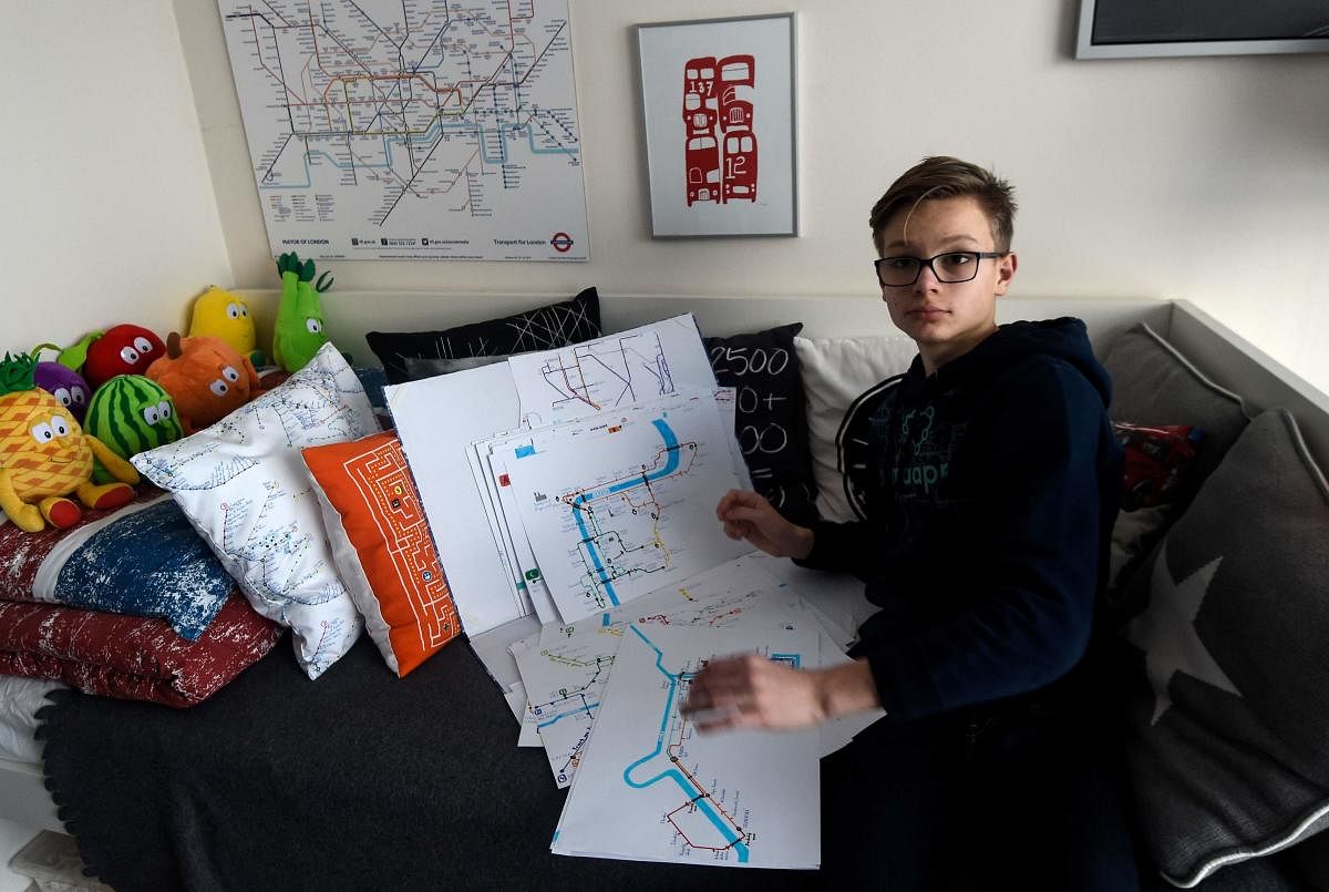 Matej Hosek, a Czech schoolboy with Asperger syndrom, shows a map that he designed. AFP