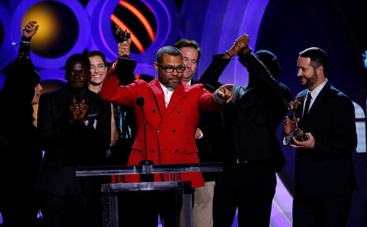 Producer and Director Jordan Peele accepts the Best Feature Award accompanied by the cast of his film 'Get Out.'  Reuters Photo