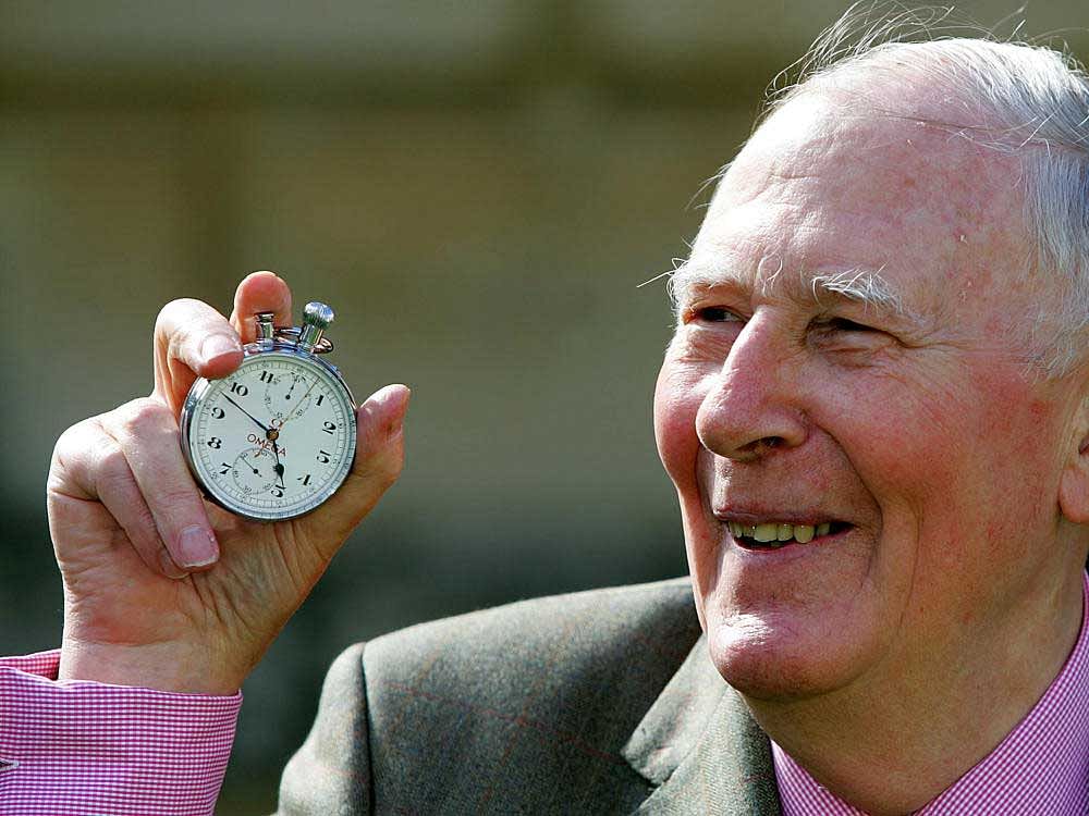 Sir Roger Bannister, who ran the first sub-four-minute mile in 1954, holds the stop watch used by Harold Abrahams to time the race during 50th anniversary celebrations at Pembroke College, Oxford, May 6, 2004. REUTERS