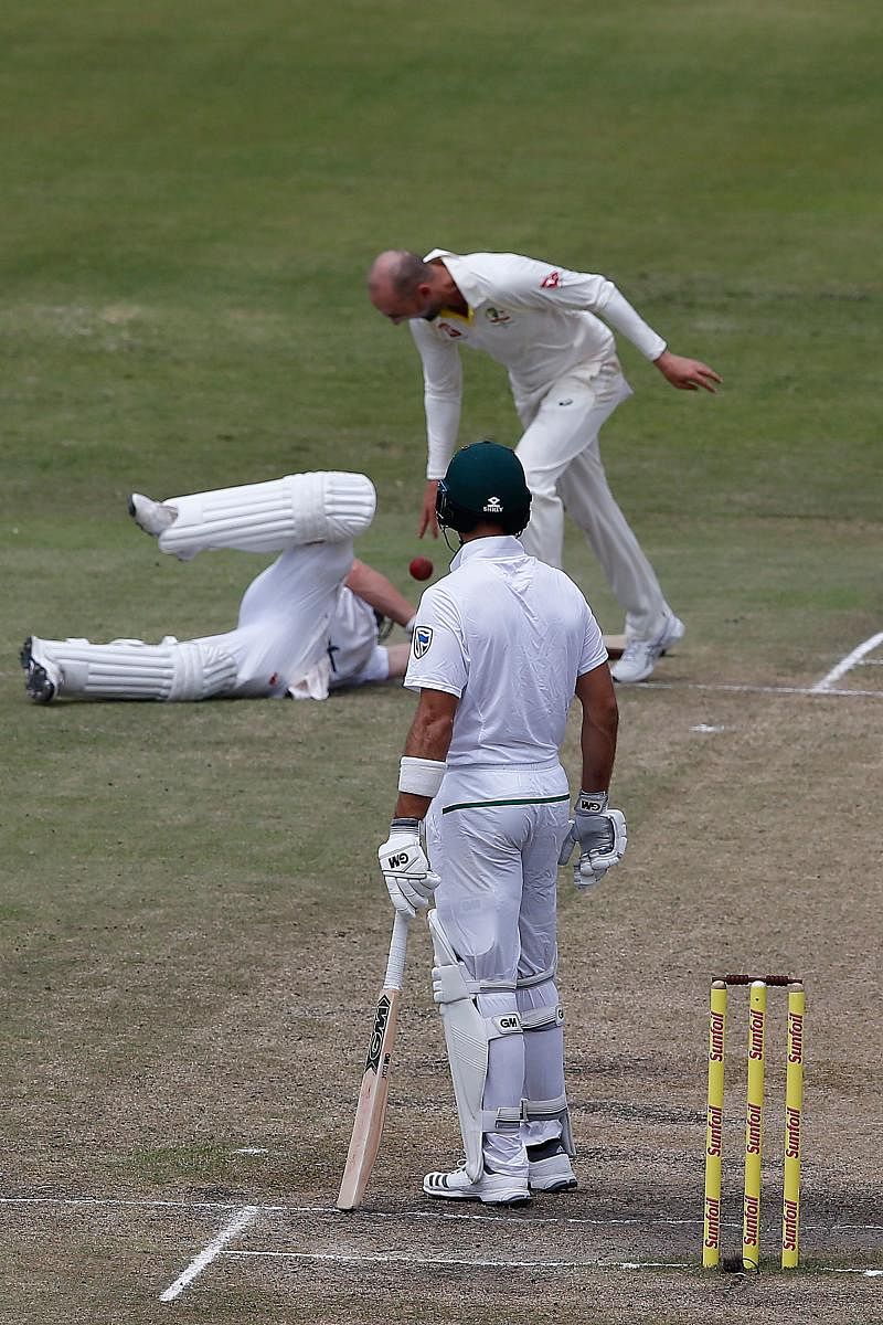 CAUGHT RED-HANDED Australia's Nathan Lyon drops the ball on South Africa's AB de Villiers (on ground) after running him out during the fourth day's play on Sunday. AFP