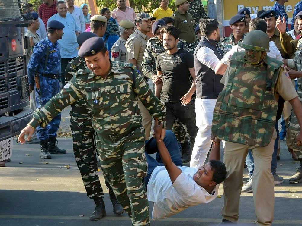 CRP personnel take away Indian Youth Congress activists during a demonstration against BJP government over the alleged Rafale fighter aircraft deal scam, near Parliament House in New Delhi on Monday. PTI Photo.