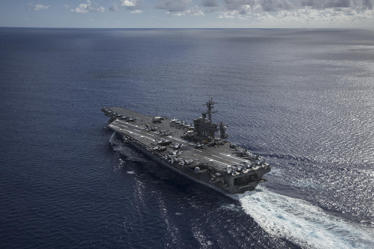 A photo provided by the U.S. Navy of the USS Carl Vinson in the Philippine Sea. For the first time since the end of the Vietnam War, the United States aircraft carrier is scheduled to make a port call in Vietnam on March 5, 2018, signaling how China's rise is bringing together former foes in a significant shift in the region's geopolitical landscape. (United States Navy via The New York Times) -- FOR EDITORIAL USE ONLY --