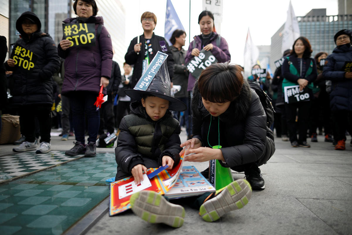 A woman takes care of her child as she attends a protest as a part of the #MeToo movement on the International Women's Day in Seoul, South Korea, March 8, 2018. REUTERS Photo