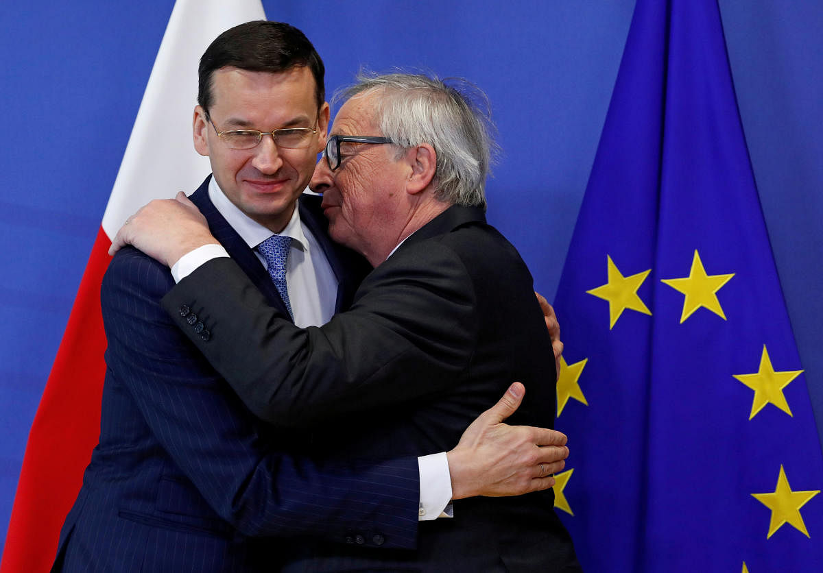 oland's Prime Minister Mateusz Morawiecki is welcomed by European Commission President Jean-Claude Juncker in Brussels, Belgium, March 8, 2018. REUTERS Photo