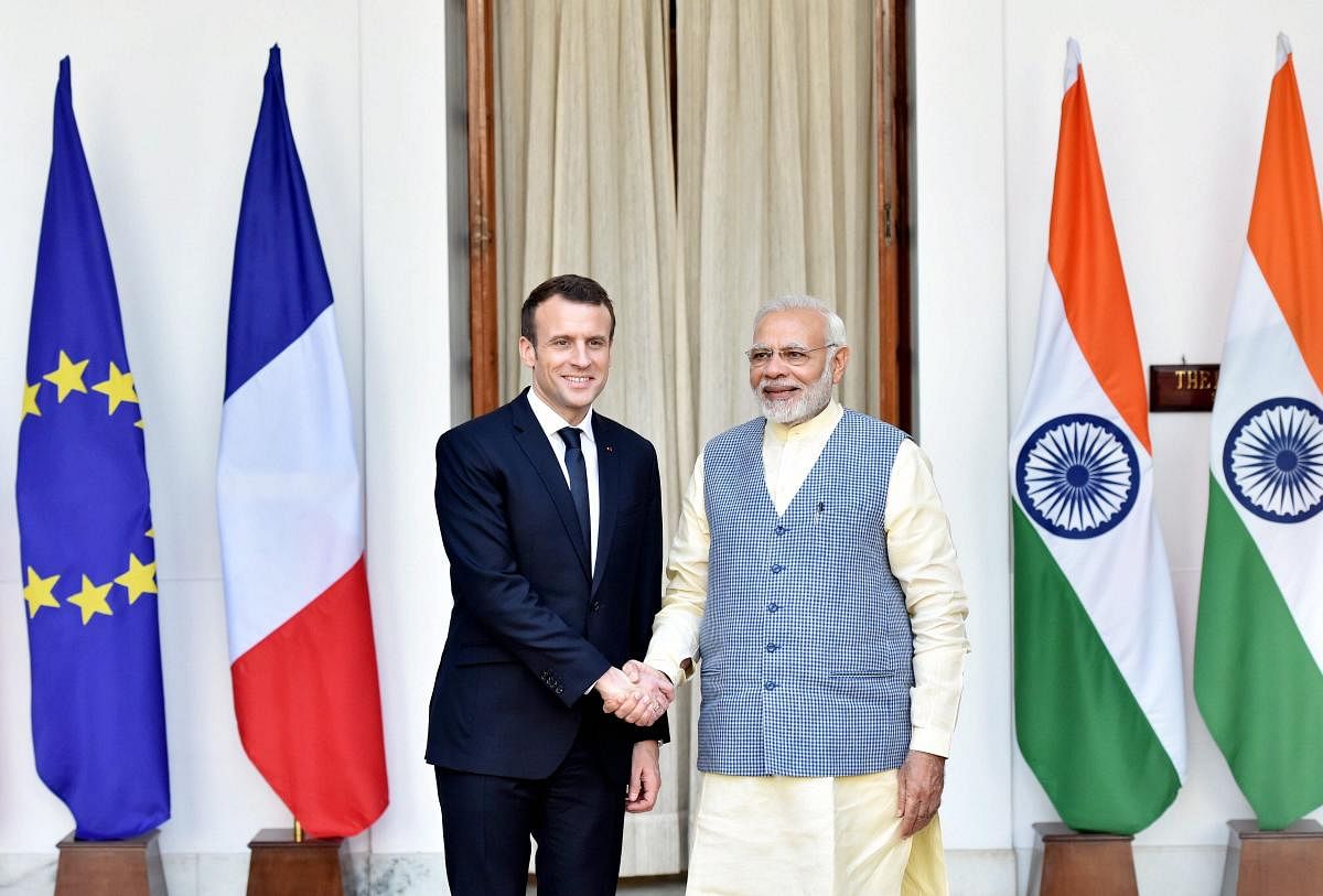 Prime Minister Narendra Modi shakes hands with French President Emmanuel Macron before their meeting at Hyderabad House in New Delhi on Saturday. PTI