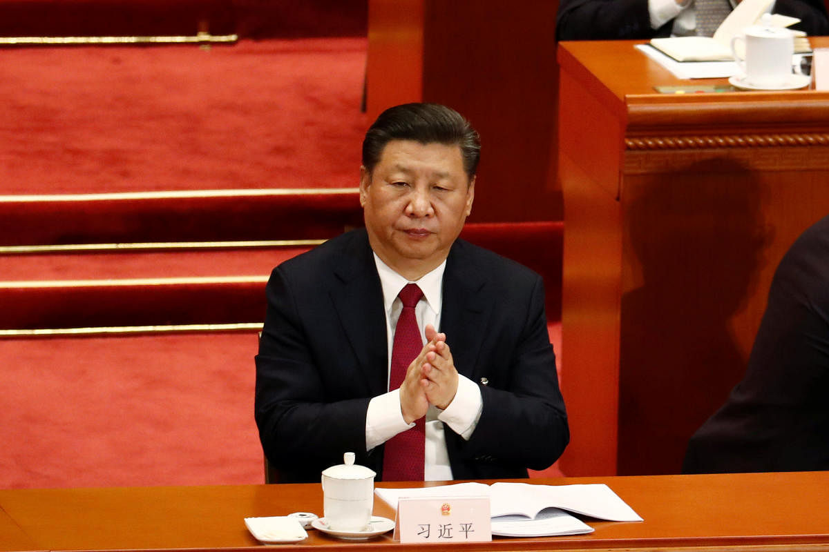 Chinese President Xi Jinping applauds after Parliament passed a constitutional amendment lifting presidential term limit, at the third plenary session of the National People's Congress (NPC) at the Great Hall of the People in Beijing, China, on Sunday. REUTERS